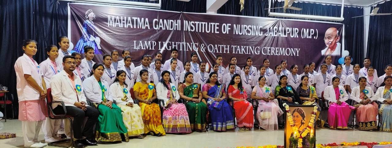 An image of Staff and Students taken during Lamp Lighting & Oath taking Ceremony at Mahatma Gandhi Institute of Nursing.