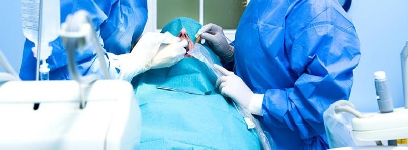 An image of doctors operating on a patient.