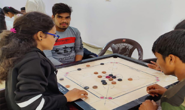 People playing carrom.